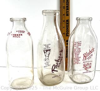 Group of three (3) antique glass milk bottles: various brands