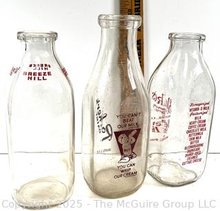 Group of three (3) antique glass milk bottles: various brands