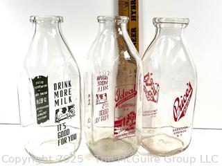 Group of three (3) antique glass milk bottles: various brands