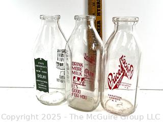 Group of three (3) antique glass milk bottles: various brands
