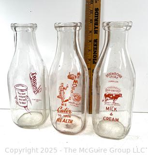 Group of three (3) antique glass milk bottles: various brands