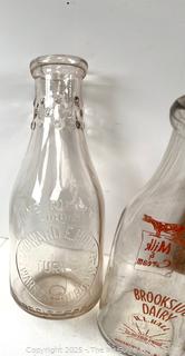 Group of three (3) antique glass milk bottles: various brands