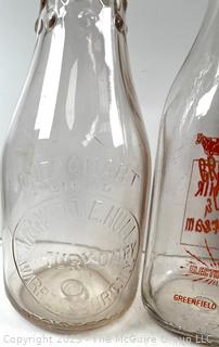 Group of three (3) antique glass milk bottles: various brands