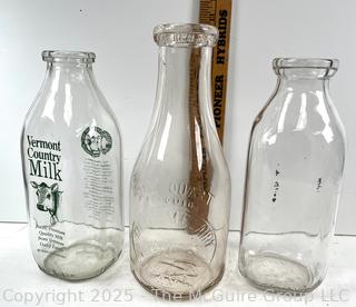 Group of three (3) antique glass milk bottles: various brands