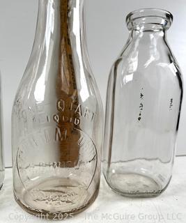 Group of three (3) antique glass milk bottles: various brands