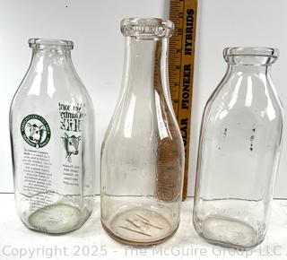 Group of three (3) antique glass milk bottles: various brands