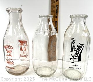 Group of three (3) antique glass milk bottles: various brands