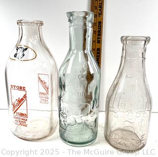 Group of three (3) antique glass milk bottles: various brands
