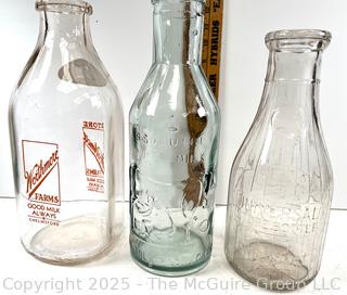 Group of three (3) antique glass milk bottles: various brands