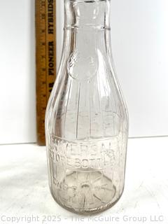 Group of three (3) antique glass milk bottles: various brands