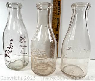 Group of three (3) antique glass milk bottles: various brands