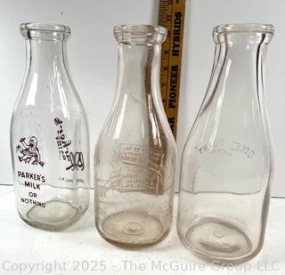 Group of three (3) antique glass milk bottles: various brands