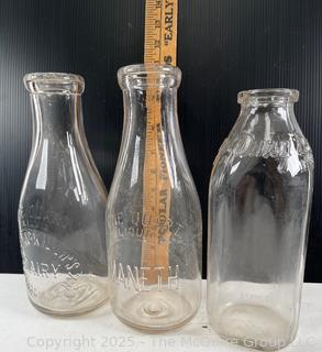 Group of three (3) antique glass milk bottles: various brands