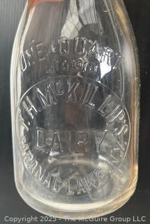 Group of three (3) antique glass milk bottles: various brands