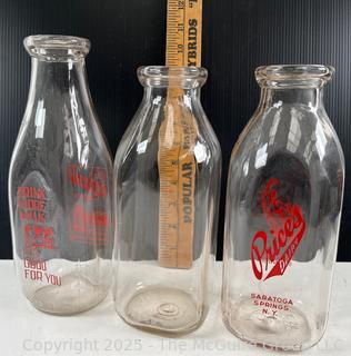 Group of three (3) antique glass milk bottles: various brands