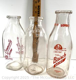 Group of three (3) antique glass milk bottles: various brands