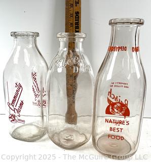 Group of three (3) antique glass milk bottles: various brands