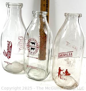 Group of three (3) antique glass milk bottles: various brands