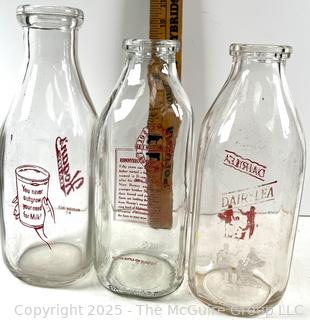 Group of three (3) antique glass milk bottles: various brands