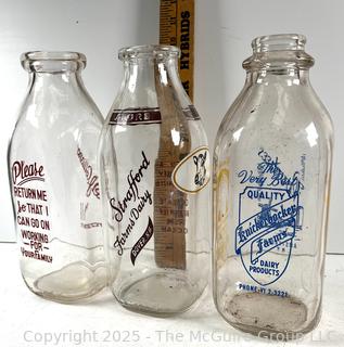 Group of three (3) antique glass milk bottles: various brands