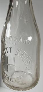 Group of three (3) antique glass milk bottles: various brands