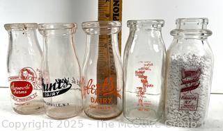 Group of five (5) antique glass milk pint bottles: various brands