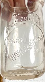 Group of five (5) antique glass pint milk bottles: various brands