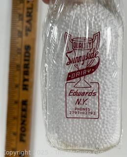 Group of five (5) antique glass pint milk bottles: various brands
