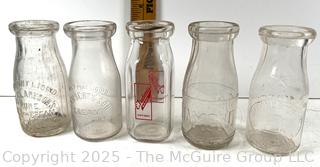 Group of five (53) antique glass milk pint bottles: various brands
