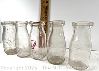 Group of five (53) antique glass milk pint bottles: various brands