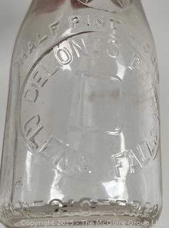 Group of five (53) antique glass milk pint bottles: various brands