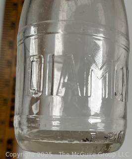 Group of five (53) antique glass milk pint bottles: various brands