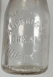 Group of five (53) antique glass milk pint bottles: various brands