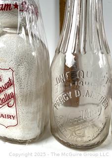 Group of five (5) antique glass milk bottles: various brands