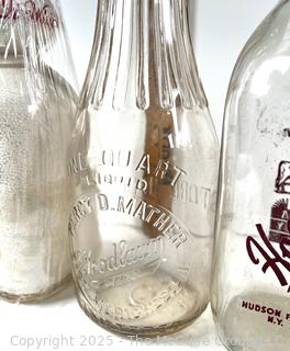 Group of five (5) antique glass milk bottles: various brands