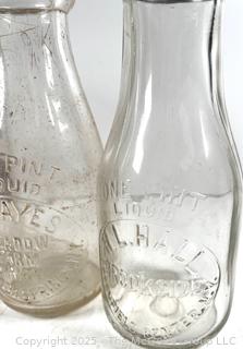 Group of five (5) antique glass milk bottles: various brands