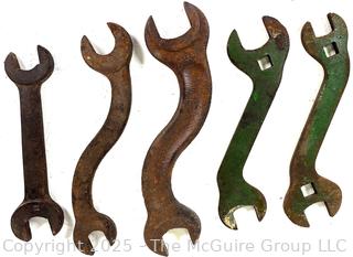 Five (5) antique iron wrenches: 4 curved, 1 straight