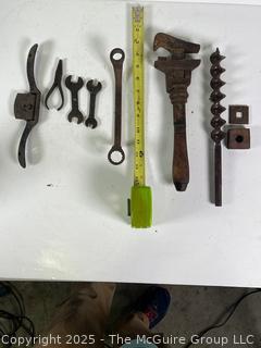 Assortment of antique hand tools: wrenches, drill bit, etc.