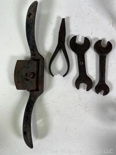 Assortment of antique hand tools: wrenches, drill bit, etc.