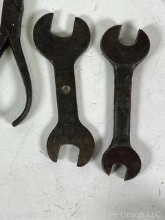 Assortment of antique hand tools: wrenches, drill bit, etc.