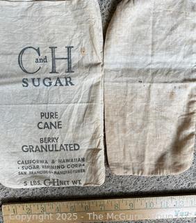 Grouping of Kitchen Ingredient Sacks Including Sugar and Flour and Kitchen Towels. See All Photos in the Gallery 