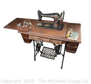 Vintage SINGER "Red Eye" Model Treadle Sewing Machine and Cabinet w/ Accessories.