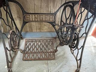 Vintage SINGER "Red Eye" Model Treadle Sewing Machine and Cabinet w/ Accessories.