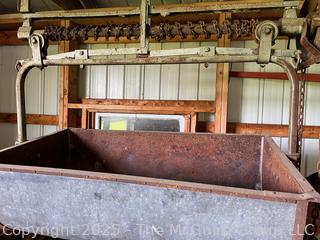 Hay or Manure Carrier System Used in Barns.  System Comprised of a Large Metal Tub Suspended From a Track or Rail. 