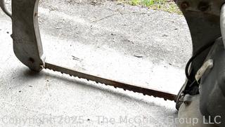 DOLMAR CB 50 Antique Chain Saw w/ Distinctive Bow Bar Designed for Easier Bucking of Wood on the Ground w/Out Excessive Bending. Dolmar is a German Company That Developed the First Gas Powered Chain Saw in 1927