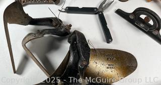 Grouping of Farm and Bench Tools Including Planet Jr. Plow Points and Branded Wrench, Marking Gage, Cow Bell, Hand Crank Jack, Oil Cans, Multi-Tool, Horseshoes and Wood Plane