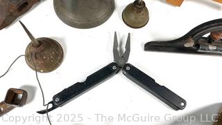 Grouping of Farm and Bench Tools Including Planet Jr. Plow Points and Branded Wrench, Marking Gage, Cow Bell, Hand Crank Jack, Oil Cans, Multi-Tool, Horseshoes and Wood Plane