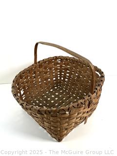 Wicker basket made of brown ash with bent handle