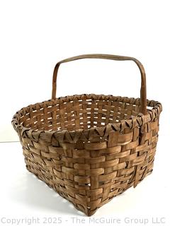 Wicker basket made of brown ash with bent handle