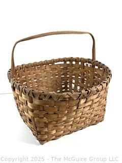 Wicker basket made of brown ash with bent handle